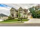 Beautiful two-story home showcasing a green lawn, mature trees, and a welcoming facade at 427 Parkbrook Way, Canton, GA 30114