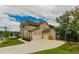 Spacious home featuring a three-car garage, and a well-maintained yard with mature trees at 427 Parkbrook Way, Canton, GA 30114