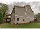 Exterior view of the house highlighting the backyard, deck, patio, and landscaping at 427 Parkbrook Way, Canton, GA 30114