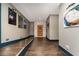 Hallway with hardwood floors, neutral walls, wall art, and bookcase at 427 Parkbrook Way, Canton, GA 30114