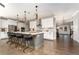 Modern kitchen featuring a center island with seating, stainless steel appliances, and pendant lighting at 427 Parkbrook Way, Canton, GA 30114