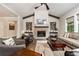 Inviting living room with brick fireplace, beamed ceiling, and hardwood flooring at 427 Parkbrook Way, Canton, GA 30114