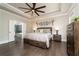 Main bedroom suite with tray ceiling, fan, hardwood floors and access to bathroom at 427 Parkbrook Way, Canton, GA 30114