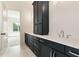 Bright bathroom featuring a double vanity with black cabinets and white quartz countertops at 6110 Harvest Way, Cumming, GA 30028