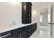 Modern bathroom featuring a double vanity with black cabinets and white quartz countertops at 6110 Harvest Way, Cumming, GA 30028