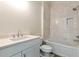 Bathroom featuring a vanity, toilet, and a tub-shower combination with tiled walls at 6110 Harvest Way, Cumming, GA 30028