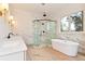 Luxurious bathroom featuring a modern soaking tub, glass shower, and stylish marble tiling at 6110 Harvest Way, Cumming, GA 30028