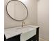 Bathroom featuring a modern sink, faucet and a round mirror at 6110 Harvest Way, Cumming, GA 30028