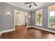 Bedroom features hardwood floors, neutral walls, ceiling fan, and access to other rooms at 6110 Harvest Way, Cumming, GA 30028