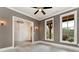 A cozy den with gray walls, white trim, and two large windows, connects to the foyer at 6110 Harvest Way, Cumming, GA 30028