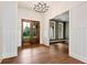 Entryway features hardwood floors, a decorative light fixture, and wooden double doors at 6110 Harvest Way, Cumming, GA 30028