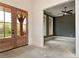 A light-filled foyer showcases beautiful wooden doors, white wainscoting, and a view into the den at 6110 Harvest Way, Cumming, GA 30028