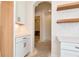 Hallway featuring white cabinets, white subway tile backsplash, and wood floating shelves at 6110 Harvest Way, Cumming, GA 30028