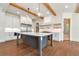 Gourmet kitchen featuring a large island, stainless steel appliances, custom cabinets, and hardwood floors at 6110 Harvest Way, Cumming, GA 30028