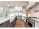 Beautiful kitchen with a large island, stainless steel appliances, custom cabinets, and hardwood floors at 6110 Harvest Way, Cumming, GA 30028