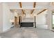 Spacious kitchen with island, custom cabinetry, wooden beams and easy access to the outdoor space at 6110 Harvest Way, Cumming, GA 30028