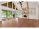 Bright living room with stone fireplace, custom built-ins, hardwood floors, and sliding doors to outdoor space at 6110 Harvest Way, Cumming, GA 30028