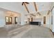 Bright living space offers wood beams, an island kitchen, and a view of the front entry from the sliding door at 6110 Harvest Way, Cumming, GA 30028