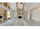 Living room featuring high ceilings, a stone fireplace with built-in shelves, and access to outdoor spaces at 6110 Harvest Way, Cumming, GA 30028