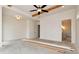Spacious bedroom featuring exposed beams, a ceiling fan and an adjacent room, possibly for a bath or closet at 6110 Harvest Way, Cumming, GA 30028