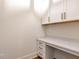 A bright and modern office space with custom built-in cabinetry, drawers, and countertop space at 6110 Harvest Way, Cumming, GA 30028
