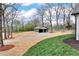 Detached outbuilding with gravel driveway and trees in a park-like setting at 6110 Harvest Way, Cumming, GA 30028