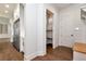Walk-in pantry featuring wood floors, stainless steel fridge, white cabinets, and shelving at 6110 Harvest Way, Cumming, GA 30028