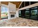 Beautiful outdoor patio featuring a stone fireplace, large sliding glass doors, and a scenic view at 6110 Harvest Way, Cumming, GA 30028