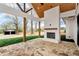 Covered patio featuring a stone fireplace, flagstone flooring, and wood beam accents at 6110 Harvest Way, Cumming, GA 30028