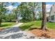 Spacious property with a detached garage, surrounded by mature trees and lush greenery at 6110 Harvest Way, Cumming, GA 30028