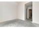 An empty, spacious room that is well lit with a hallway visible at 6110 Harvest Way, Cumming, GA 30028