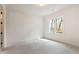 Empty room with a large window, ceiling light, and white walls at 6110 Harvest Way, Cumming, GA 30028