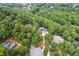 Expansive property viewed from above, revealing a stunning home surrounded by verdant trees and other residences at 2885 Coles Way, Atlanta, GA 30350