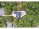 Aerial view of wooded property, showcasing home, pool, circular driveway, and lush landscaping at 2885 Coles Way, Atlanta, GA 30350