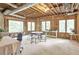Unfinished basement with a wooden frame, several windows with views, and flexible area for a dining or office space at 2885 Coles Way, Atlanta, GA 30350