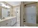 Bathroom showcasing a double vanity with a tub/shower combo with gold trim at 2885 Coles Way, Atlanta, GA 30350