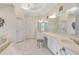 Bright bathroom featuring dual sinks, vanity area, tile flooring, and decorative wall accents at 2885 Coles Way, Atlanta, GA 30350