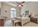 Comfortable bedroom with neutral carpet, traditional furniture, and large bright window at 2885 Coles Way, Atlanta, GA 30350