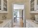 Butler's pantry featuring white cabinetry, countertops, and an opening to the dining room at 2885 Coles Way, Atlanta, GA 30350