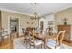 Formal dining room with a chandelier, hardwood floors, and a view to the kitchen at 2885 Coles Way, Atlanta, GA 30350