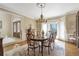 Elegant dining room with a chandelier, hardwood floors, and large bay window at 2885 Coles Way, Atlanta, GA 30350