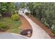 A picturesque home featuring a long private driveway and landscaped grounds, creating a serene and inviting entrance at 2885 Coles Way, Atlanta, GA 30350