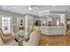 Open-concept kitchen and dining area with white cabinets and hardwood floors at 2885 Coles Way, Atlanta, GA 30350