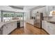 Spacious kitchen featuring stainless steel appliances, white cabinets, and hardwood floors at 2885 Coles Way, Atlanta, GA 30350