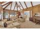 Expansive living room with beamed ceiling, fireplace, and an open layout to kitchen at 2885 Coles Way, Atlanta, GA 30350