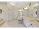 Bright bathroom with white tile, large mirrors, vanity, and chandeliers at 2885 Coles Way, Atlanta, GA 30350