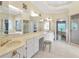Bathroom with large mirrors, white tile, double vanity, and walk-in shower at 2885 Coles Way, Atlanta, GA 30350
