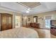 Spacious main bedroom featuring hardwood floors, tray ceilings, and a doorway to the main bathroom at 2885 Coles Way, Atlanta, GA 30350