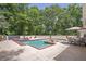 Inviting outdoor space showcasing a pool, hot tub, patio furniture, and mature trees, perfect for entertaining and relaxation at 2885 Coles Way, Atlanta, GA 30350