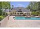 A stunning backyard featuring a spacious pool with a spa, patio, and lush landscaping surrounding a stately home at 2885 Coles Way, Atlanta, GA 30350
